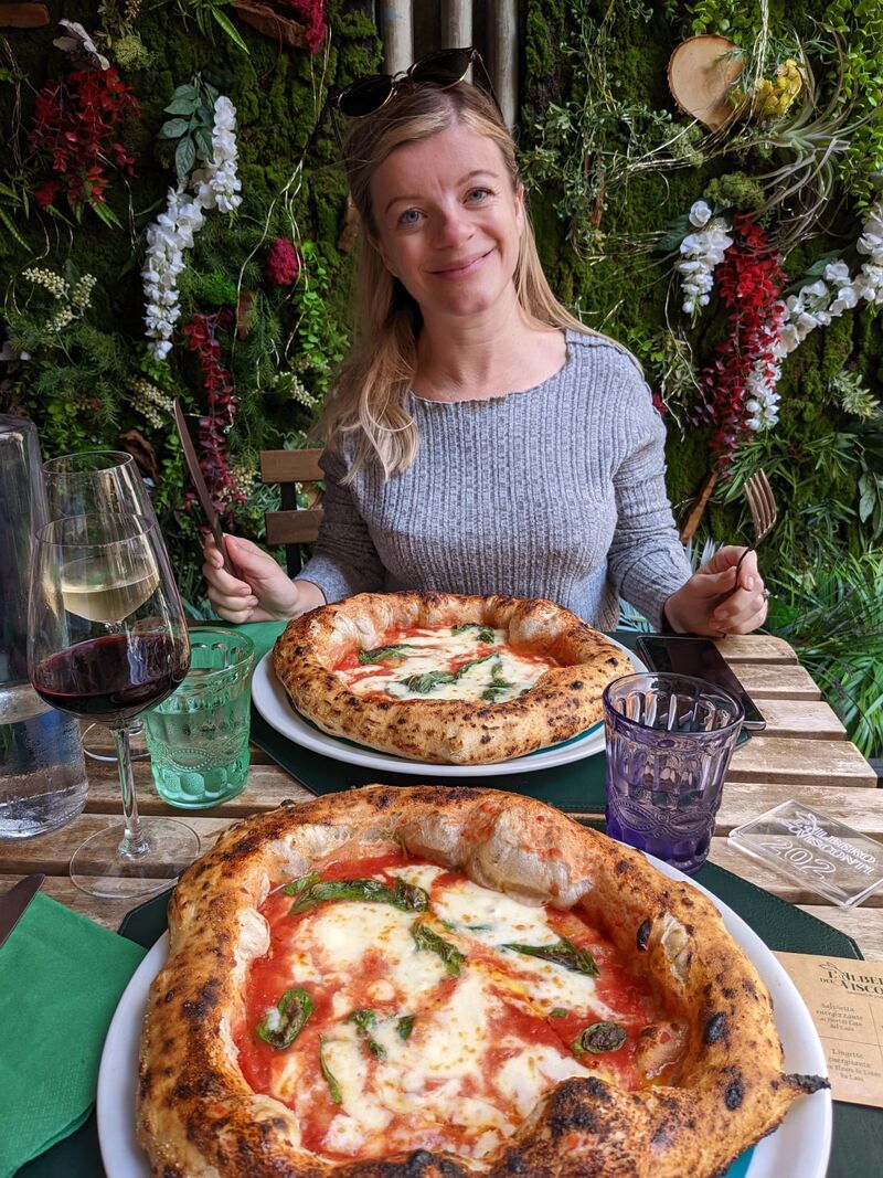 Rosie Johnstone, founder of Pizza Club, at a table with two pizzas